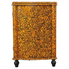 an orange and black cabinet with wheels on the bottom, sitting against a white background