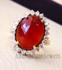 Cluster 18K Gold carnelian red aqeeq agate ladies ring red cabochon oval stone all sizes jewelry classic style white cubic zircon around Risk free Quality guarantee policy : If you are not satisfied with your item for any reason simply send it to us and you will get a replacement or refund . please write or choose your size with the order and we will size it for you . Our ring is handcrafted mostly with a few simple tools . but some methods are used in casting like lost wax method . 18 k gold st Aqeeq Ring Designs Women, Oval Gold Diamond Cabochons, Formal Carnelian Oval Cabochon Jewelry, Exquisite Oval Gemstone Cabochons, Polished Diamond Cabochons As Gifts, Elegant Ruby Ring With Oval Cabochon Gemstone, Formal Oval Cabochon Carnelian Jewelry, Elegant Oval Cabochon Ruby Ring, Oval Diamond Cabochon Gift