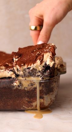 someone is dipping some ice cream on top of a cake