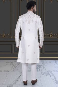 This impeccable sherwani, adorned with luxurious stones and intricate embroidery, exudes sophistication and elegance. Perfect for the stylish groom, it is a timeless masterpiece that will make a lasting impression. Indulge in the opulence and elevate your wedding day look with this R14-S71 sherwani. Elegant Traditional Wear With Naqshi, Elegant Traditional Wear With Naqshi Drape, Elegant Traditional Wear With Naqshi In Traditional Drape, Traditional White Kurta With Naqshi Drape, Elegant Churidar With Resham Embroidery For Ceremonial Occasions, White Kurta With Naqshi And Traditional Drape, Elegant Ceremonial Churidar With Resham Embroidery, White Kurta With Naqshi In Traditional Drape, Elegant Unstitched Kurta For Ceremonial Occasions