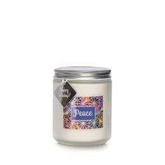 a white candle with the word peace in blue and purple on it's lid