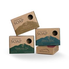 three soap bars stacked on top of each other with mountains and trees in the background