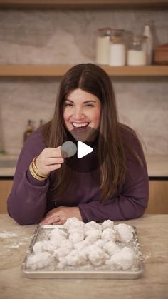 a woman sitting at a table with some food in front of her and the caption that reads, how to make snowball cookies