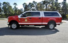 a red fire truck parked in a parking lot