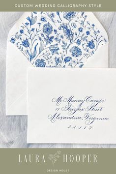 an envelope with blue flowers on it and the words, custom wedding calligraphy style