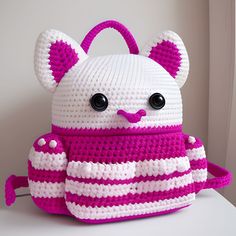 a crocheted white and pink teddy bear purse