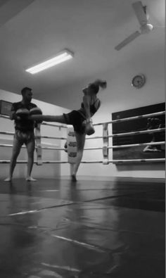 black and white photograph of two people in a boxing ring