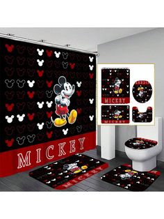 a bathroom with mickey mouse rugs, toilet and shower curtain in black and red