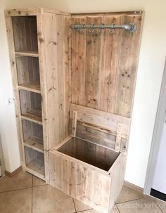 an empty wooden storage unit in the corner of a room