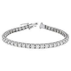 Elevate your style with this exquisite 18K White Gold Four Prong Tennis Bracelet. Crafted with meticulous attention to detail, it features a continuous line of dazzling round-cut natural diamonds, totaling 4.00 carats. Each diamond is expertly hand-set in a secure four-prong setting, allowing for maximum brilliance and light reflection. The white tones of the 18K white gold complement the diamonds beautifully, creating a radiant and luxurious piece that is sure to captivate. This tennis bracelet is designed to be a showstopper, commanding attention with its brilliant display of 4.00 carats of natural diamonds. The meticulously crafted links ensure a comfortable fit, while the secure four-prong settings offer both protection and an enhanced showcase of the diamonds' beauty. Whether worn as European Modern, Bracelet Tennis, Continuous Line, Tennis Bracelet, Elegant Gift, San Valentino, Diamond White, Diamond Shapes, Arm Band