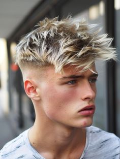 The textured crop with a high fade and blonde highlights is a bold, eye-catching option that combines striking color with a modern cut. The textured top is highlighted with blonde streaks, adding dimension and contrast, while the high fade creates a sharp, clean look. This style is great for parties or high-fashion events and suits men with angular face shapes and light eye colors. Mens Hair Color Ideas Blonde, Men’s Blonde Highlights Short Hair, Blonde Highlights For Men, Mens Hair Highlights Blondes, Blonde Highlights On Brown Hair Men, Male Highlights, Men’s Highlights Dark Blonde, Male Blonde Hair, Men Blonde Highlights