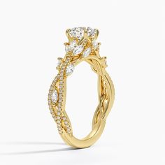 a yellow gold engagement ring with diamonds on it