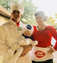 a man and woman dressed up as chefs holding a baby