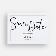 save the date card with black ink and gold foil on white paper, in front of a