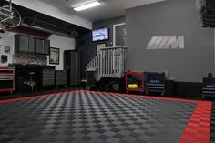 the inside of an auto showroom with red walls and black checkered flooring