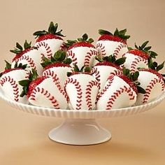 a white platter filled with strawberries on top of a table