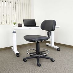 an office chair sitting in front of a desk with a laptop computer on top of it