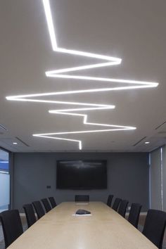 an empty conference room with chairs and a projector screen