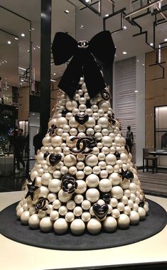 a christmas tree made out of balls and black bows