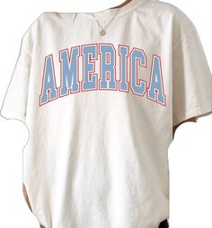 an american t - shirt with the word america on it is hanging from a clothes hanger