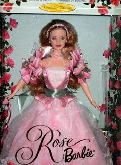 a barbie doll in a pink dress and tiara with roses around her neck, wearing a tiara