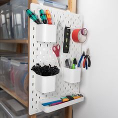 the pegboard is organized with office supplies