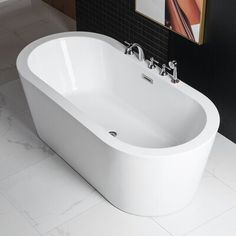 a white bath tub sitting on top of a bathroom floor