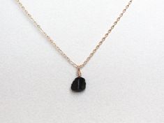 Raw black tourmaline, is one of the most sought after stones for protection and purification.  It helps to prevent the intrusion of negative or unwanted energies and to ground oneself.  Discreet necklace with a small raw black tourmaline which has been wrapped with fine wire. Due to the simple design, it can be worn with all outfits and makes a great gift for yourself and your loved ones. ✺ MATERIAL ✺  Only Pendant:  Wire material  -Gold Filled -Sterling Silver 925  With chain: - Delicate Gold ( Black Tourmaline Jewelry With Natural Stones, Minimalist Black Necklace With Natural Stones, Black Tourmaline Jewelry As Gift, Black Tourmaline Jewelry Gift, Black Tourmaline Necklace With Natural Stones, Minimalist Black Pendant Crystal Necklace, Minimalist Black Crystal Necklace As A Gift, Stones For Protection, Necklaces Black