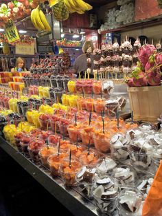 many different kinds of candies on display in a store