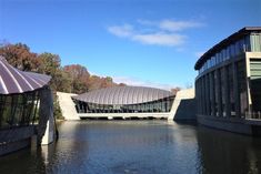 the building is designed to look like a domed glass house on top of a lake