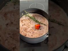 a pot filled with soup sitting on top of a stove