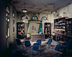 an old room with several chairs and shelves