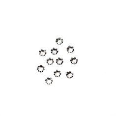 six pairs of black and white diamond studs on a white background with space for text