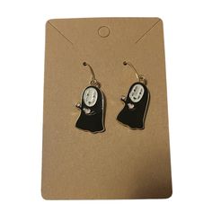 a pair of earrings with a ghost on it