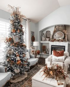 a living room decorated for christmas with a tree in the corner and other holiday decorations