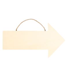 an arrow sign hanging from the side of a white wall