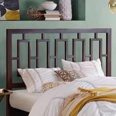 a bedroom with green walls and white bedding