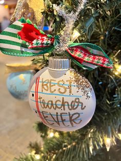 a christmas ornament hanging from the side of a tree with writing on it