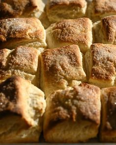 a pan filled with rolls covered in powdered sugar