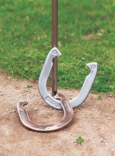 an upside down metal hook on the ground