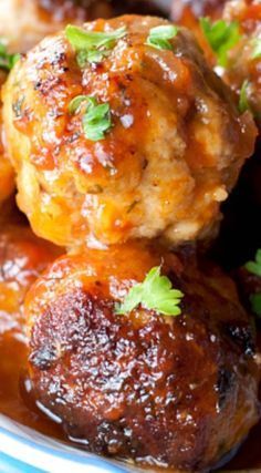 meatballs with sauce and parsley in a bowl