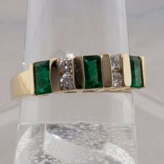 14K Yellow Gold 1 ct Emerald and Diamond Modernist Ring, Fine Quality alternating emeralds and diamonds, 3 emerald cut 3 x 5mm emeralds, 4 round 2.8 mm diamond side stones, sits .25 inch off finger, .82 inch across, Ring size 7, 4.7 grams Stock # BB319R20 This listing contains photographs of the actual item you will receive. Our items are in excellent condition with little or no signs of wear and many are one of a kind pre-owned estate finds. Please look closely at the pictures in this listing a Green Diamond Ring With Single Cut Emerald Shape, Green Emerald Cut Diamond Ring With Single Cut Diamonds, Emerald Cut Emerald Ring With Multi-stone Diamond, Emerald-cut Multi-stone Diamond Emerald Ring, Formal Emerald Cut Ring With Single Cut Diamonds, Green Emerald Cut Multi-stone Diamond Ring, Emerald Cut Green Diamond Ring With Multi-stone, Emerald Cut Multi-stone Emerald Jewelry, Emerald Cut Green Multi-stone Diamond Ring