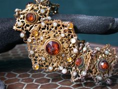 "WE SELL THIS NICE ANTIQUE AUSTRO HUNGARIAN BRACELET, MADE IN METAL WITH GOLD GILT FINISHED DECORATED WITH STONES and faux seed PEARLS , IN GOOD CONDITION ,HAS SOME SIGNS OF WEAR COMMENSURATE WITH AGE AND USE , MAYBE NEEDS SOME CLEANNING, HAS SOME STAINS, MISSING little seed pearl, PLEASE SEE PICTURES AND TAKE AS A PART OF ITEM DESCRIPTION, i list for sale ASIS as pictured the measures are 7 3/4\" X 1 1/2\"WEIGHT 33.3gr As is a vintage antique item , it's unique , for that if you like to wear it Antique Gold Jeweled Jewelry For Weddings, Victorian Antique Gold Bracelet, Antique Jeweled Jewelry For Wedding, Victorian Jeweled Evening Jewelry, Victorian Jeweled Wedding Bracelets, Heirloom Jeweled Bracelets For Wedding, Heirloom Jeweled Wedding Bracelets, Elegant Gold Bracelets For Vintage Events, Vintage Jewelry With Historical Design For Evening