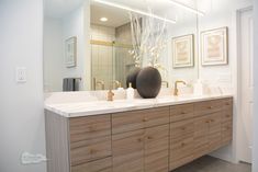 a bathroom with two sinks and a large mirror over it's counter top,