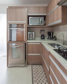 a kitchen with wooden cabinets and stainless steel appliances