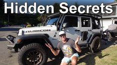 a man sitting in front of a jeep with the words hidden secrets on it's side