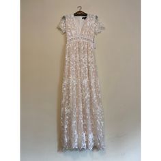 This Is A New With Tags White/Ivory Floral Lace Maxi Dress By The Brand Aakaa. It Was Available At A Boutique And Has Writing In The Tag From The Boutique. The Dress Has A Deep V-Neckline, Short Sleeves, And A Fitted Bodice. It Features A Delicate Floral Embroidery Pattern Throughout The Dress. The Dress Is Made Of A Lightweight, Sheer Fabric And Has A Flowy Silhouette. The Dress Has A Back Zipper Closure And Is Lined To Mini Dress Length. The Dress Measures Approximately 54 Inches In Length, 15 Cream Lace Maxi Dress For Brunch, Cream Lace Midi Maxi Dress, Cream Lace Maxi Dress For Party, Feminine Off White Short Sleeve Maxi Dress, Feminine Off-white Short Sleeve Maxi Dress, Off White Fitted Lace Maxi Dress, Off-white Fitted Lace Maxi Dress, Off White Lace Maxi Dress, Elegant Off White Short Sleeve Maxi Dress