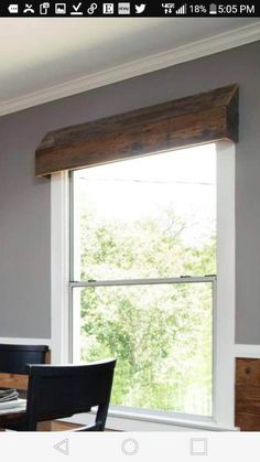 a dining room table and chairs with a window in the background