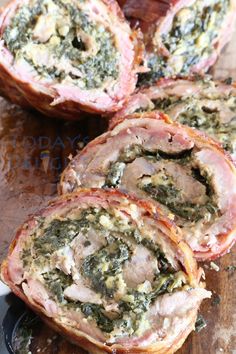 ham and spinach stuffed with cheese on a cutting board