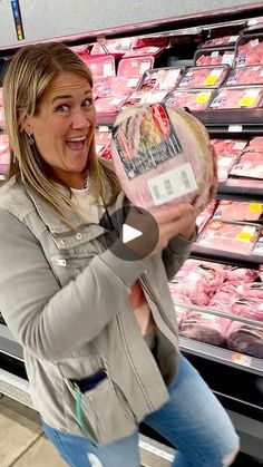 a woman holding up a piece of meat in her hand